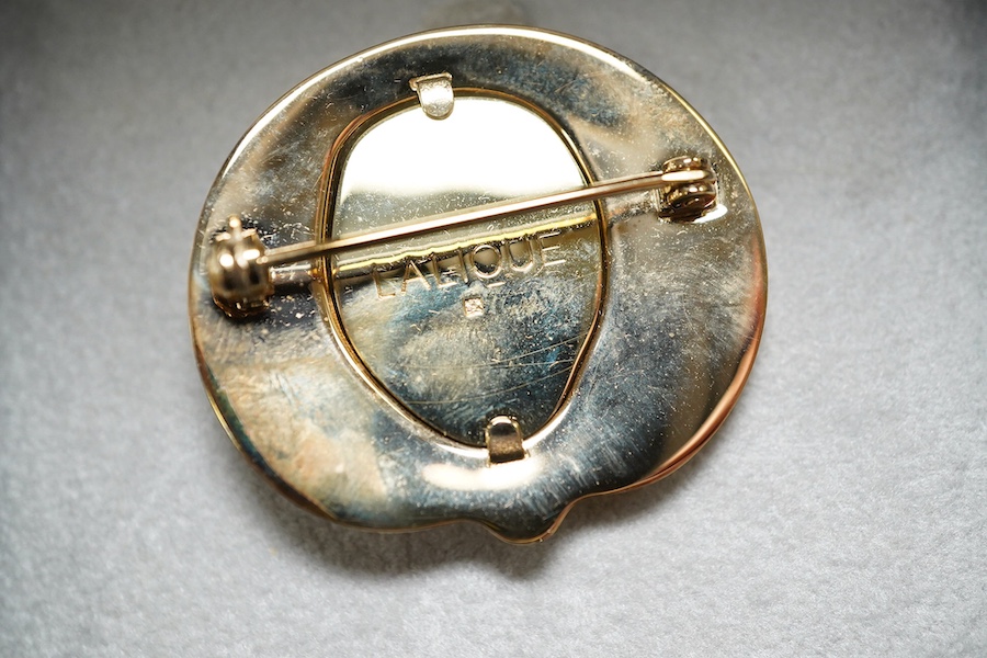 A Lalique mask brooch, cased